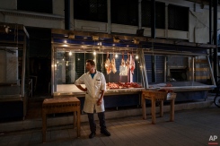 A butcher wait for clients in a market in Athens, Tuesday, June 23, 2015 . Greece this week offered a series of measures, including multiple tax increases, to persuade its creditors to release bailout funds and keep the country from defaulting on its debts as soon as next week. (AP Photo/Daniel Ochoa de Olza)