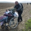 In this Tuesday, March 1, 2016 photo, Hamo from Iraq pushes a wheelchair with his 8-year old disabled daughter Sidra through fields in their effort to arrive at the Greek border station of Idomeni. The fields of Idomeni were never a proper border crossing between Greece and Macedonia. It’s where the freight trains cross, and earlier in the crisis refugees and migrants traveling clandestinely through the Balkans used it as they followed the tracks on foot north toward central Europe. Soon it became a major staging point in the biggest mass movement of people the continent has seen since vast displaced populations were being repatriated in the bloody aftermath of World War II. (AP Photo/Petros Giannakouris)