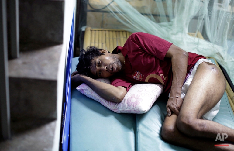 In this Friday, Dec. 12, 2014 photo, Min Min, from Myanmar, rests on a make-shift bed. Min Min was rescued from a tiny island two months ago, on the verge of starvation, and brought back to Thailand, the world's third-largest seafood exporter. Concerns about labor abuses, especially at sea, prompted the U.S. State Department last year to downgrade Thailand to the lowest level in its annual human trafficking report, putting the country on par with North Korea, Iran and Syria. (AP Photo/Wong Maye-E)