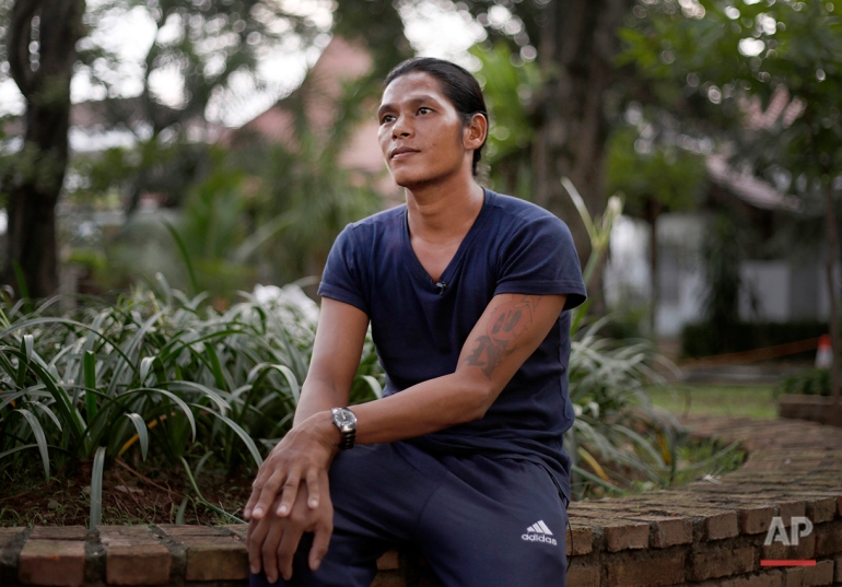 In this Monday, April 6, 2015 photo, former fishing slave Kyaw Naing pauses during an interview with the Associated Press in Jakarta, Indonesia. Kyaw Naing, who was at one point kept in a cage on the remote island of Benjina, is among eight migrant fishermen rescued for their safety in the course of an Associated Press investigation into slavery in the seafood industry. Hundreds of others evacuated by the Indonesian government after the story are waiting to be repatriated. (AP Photo/Dita Alangkara)