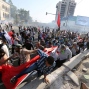 Protesters run from tear gas fired by Iraqi security forces to disperse the crowd in central Baghdad, Iraq, Friday, May 27, 2016. Thousands of protesters including followers of influential Shiite cleric Muqtada al-Sadr took to the streets and rallied calling for comprehensive reforms and a new technocrat reshuffle. Dozens of demonstrators suffered from tear gas inhalation.(AP Photo/Hadi Mizban)