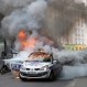 A man tries to pull off fire on a burning police car during clashes while police forces gather to denounce the almost daily violent clashes at protests against a labor reform, Wednesday, May 18, 2016 in Paris. Several hundred counter-demonstrators came by, chanting slogans like “Everybody hates the police!” and pushing up against the officers until eventually the police deployed pepper spray. (AP Photo/Francois Mori)