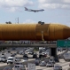 A cargo plane flies overhead as the last remaining space shuttle external propellant tank is moved across the 405 freeway in Los Angeles on Saturday, May 21, 2016. The ET-94 will be displayed with the retired space shuttle Endeavour at the California Science Center. (AP Photo/Chris Carlson)