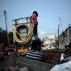 Palestinian children climb on a portable tank used to distribute water in el-Zohor slum, on the outskirts of Khan Younis refugee camp, southern Gaza Strip, Monday, June 20, 2016. (AP Photo/Khalil Hamra)