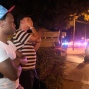 Jermaine Towns, left, and Brandon Shuford wait down the street from a multiple shooting at a nightclub in Orlando, Fla., Sunday, June 12, 2016. Towns said his brother was in the club at the time. A gunman opened fire at a nightclub in central Florida, and multiple people have been wounded, police said Sunday. (AP Photo/Phelan M. Ebenhack)